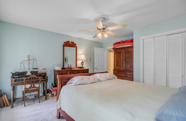 carpeted bedroom featuring a closet and ceiling fan