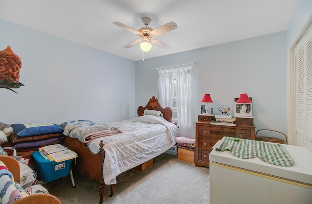 carpeted bedroom with a closet and a ceiling fan