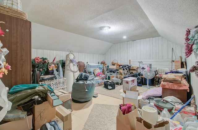 additional living space with lofted ceiling and a textured ceiling