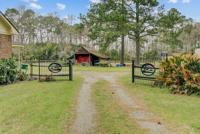 view of street featuring a gated entry, a gate, and driveway