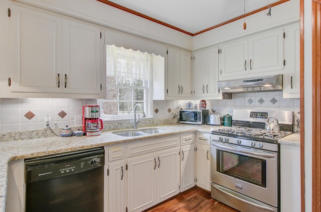 kitchen featuring a sink, dishwasher, under cabinet range hood, gas range, and white cabinets