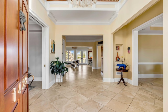 entrance foyer featuring ornamental molding and baseboards