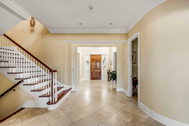 foyer entrance with light tile patterned floors, baseboards, stairs, and ornamental molding