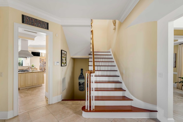 staircase with tile patterned flooring, visible vents, ornamental molding, and baseboards