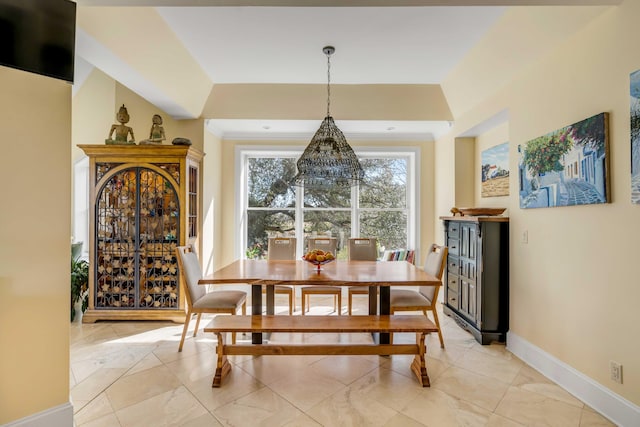 dining area featuring baseboards and crown molding