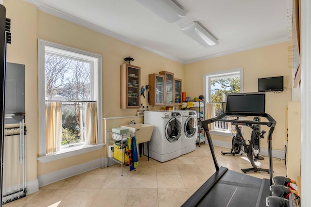 laundry room with ornamental molding, laundry area, a healthy amount of sunlight, and separate washer and dryer