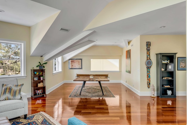 game room with light wood-type flooring, a wealth of natural light, vaulted ceiling, and baseboards