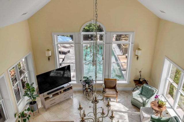 living room featuring high vaulted ceiling, baseboards, and light tile patterned floors