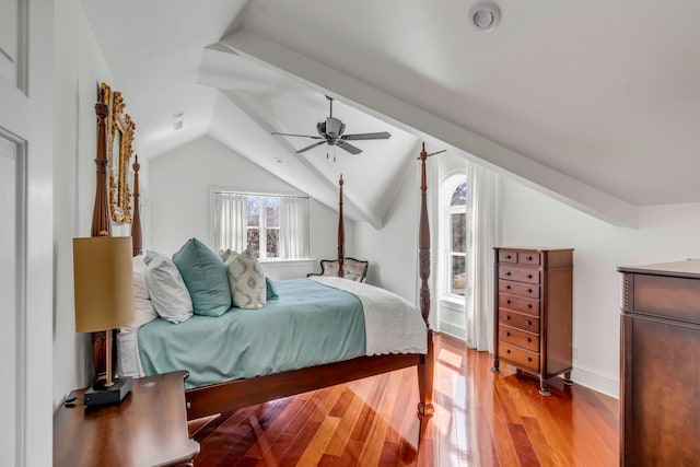 bedroom featuring lofted ceiling, light wood-style flooring, baseboards, and ceiling fan