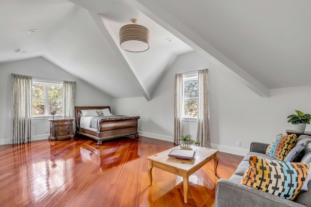 bedroom with lofted ceiling, baseboards, and wood finished floors