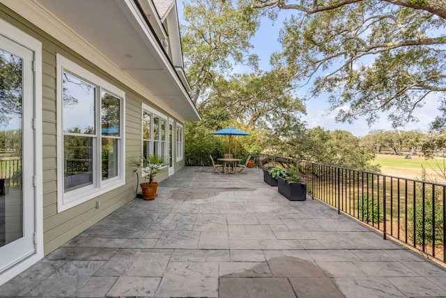 view of patio featuring fence and outdoor dining space