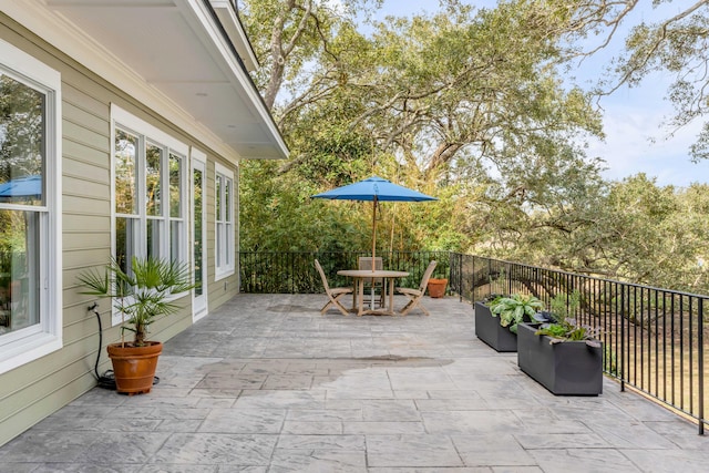 view of patio / terrace with outdoor dining space and fence