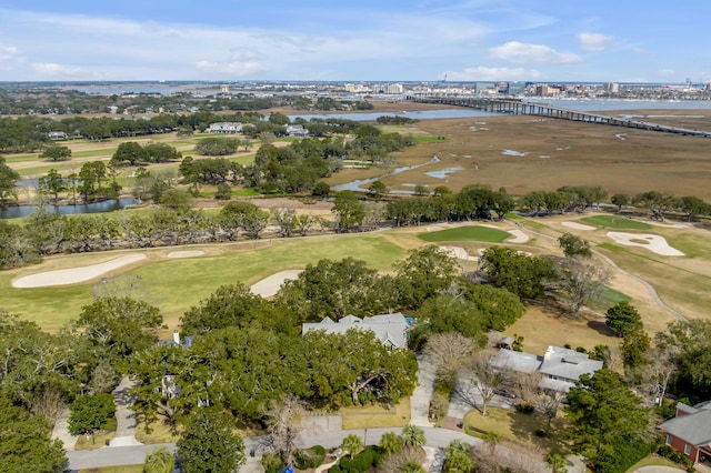 drone / aerial view featuring view of golf course and a water view