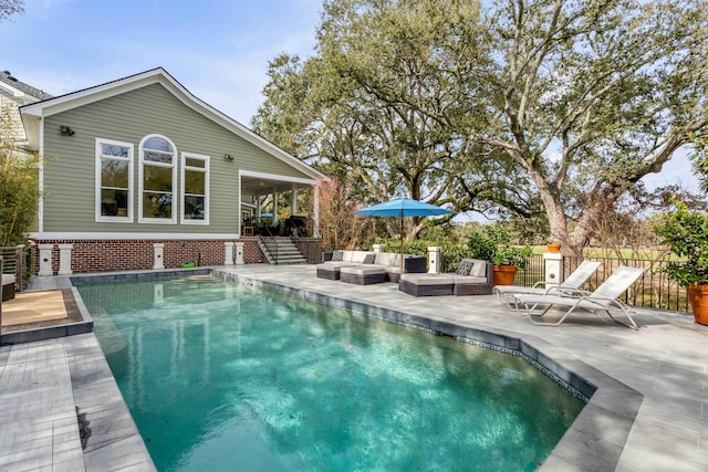 view of pool featuring an outdoor hangout area, fence, and a fenced in pool