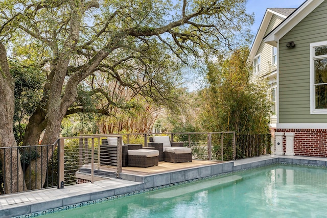 view of pool with a fenced in pool and fence