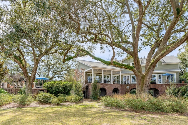 view of front of home with a front yard and brick siding