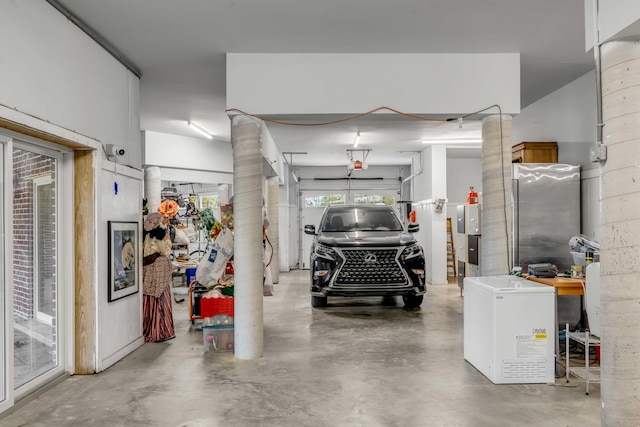 garage featuring a garage door opener, freestanding refrigerator, and refrigerator