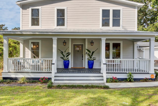 view of front of property with a front yard and covered porch