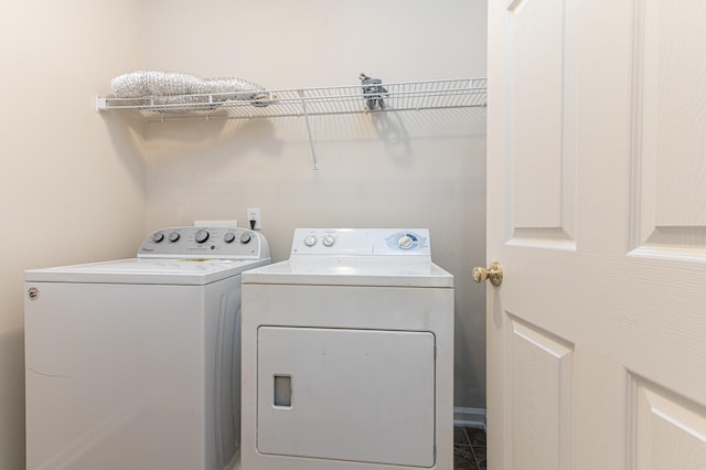 washroom featuring tile flooring and separate washer and dryer