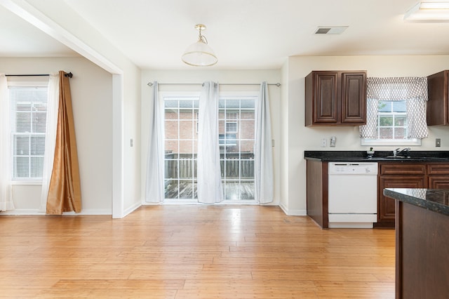 kitchen featuring light hardwood / wood-style flooring, hanging light fixtures, a wealth of natural light, and dishwasher