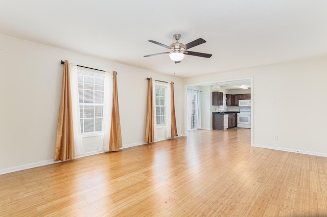 empty room featuring ceiling fan and light wood-type flooring