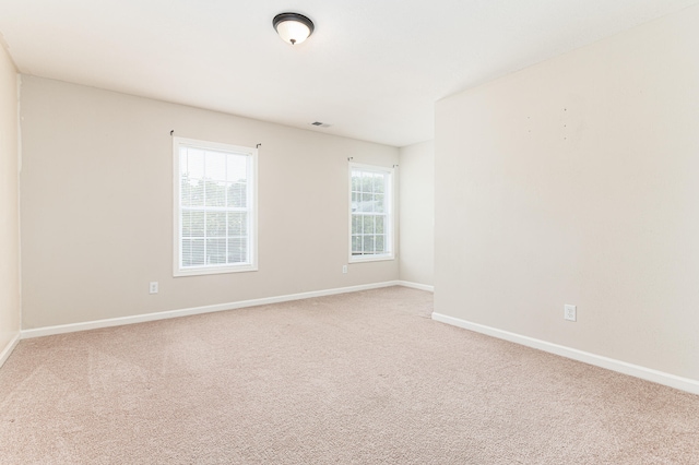 empty room with light colored carpet
