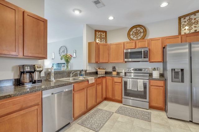 kitchen featuring visible vents, recessed lighting, appliances with stainless steel finishes, brown cabinets, and a sink