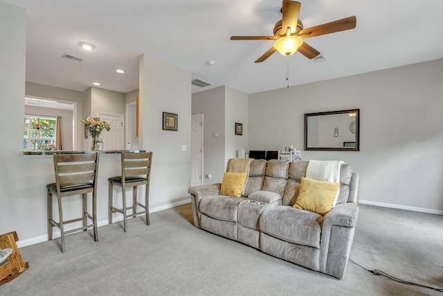 carpeted living room featuring visible vents and baseboards