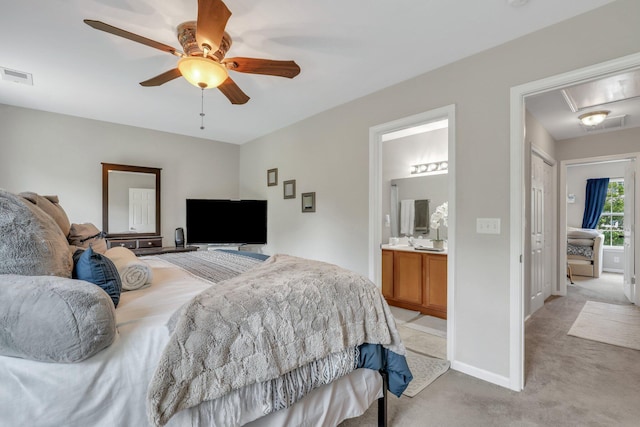 bedroom with visible vents, light carpet, connected bathroom, baseboards, and attic access