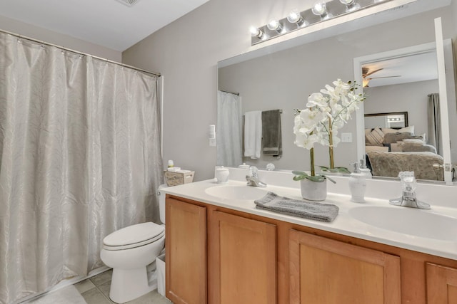 ensuite bathroom with ensuite bath, double vanity, toilet, and a sink