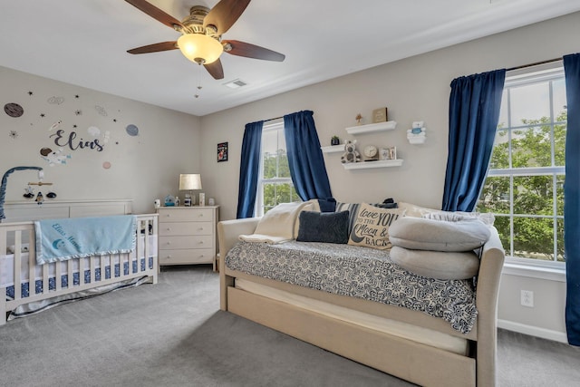 carpeted bedroom featuring visible vents, baseboards, and ceiling fan