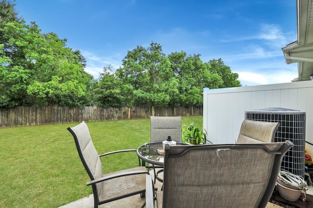 view of patio with central air condition unit, outdoor dining area, and fence