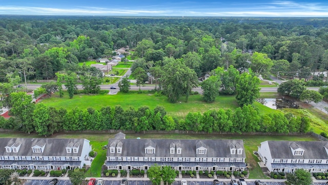 aerial view featuring a water view and a wooded view