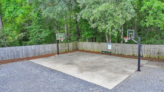 view of sport court featuring a fenced backyard and community basketball court