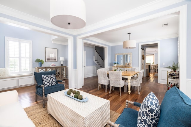 living room featuring dark hardwood / wood-style flooring and ornamental molding