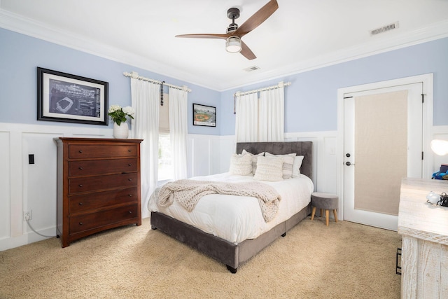 bedroom featuring light carpet, ceiling fan, and ornamental molding