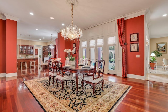 dining area featuring crown molding, dark hardwood / wood-style flooring, and a notable chandelier