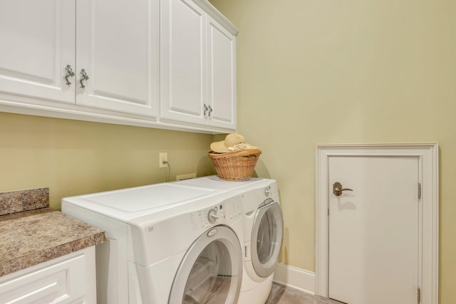 washroom featuring cabinets and washer and dryer