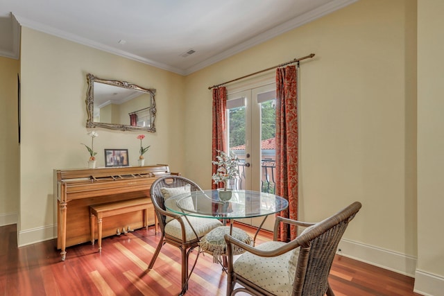 dining room featuring crown molding, french doors, and hardwood / wood-style floors