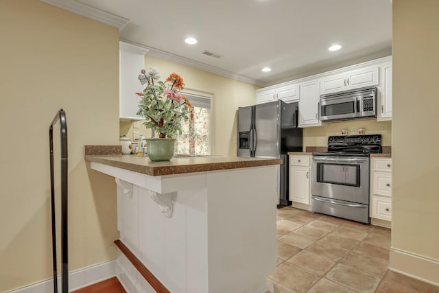 kitchen with stainless steel appliances, ornamental molding, kitchen peninsula, and white cabinets