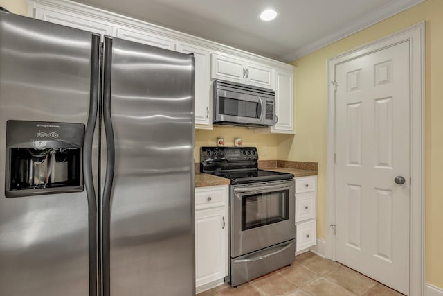 kitchen featuring crown molding, stainless steel appliances, light tile patterned floors, and white cabinets