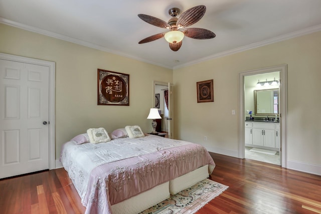 bedroom with dark wood-type flooring, ensuite bath, ornamental molding, and ceiling fan