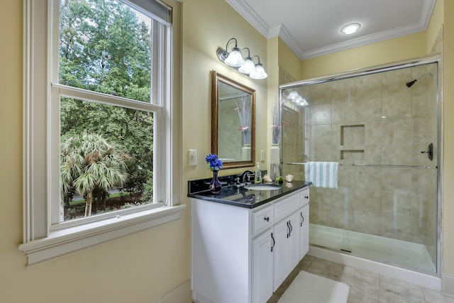 bathroom with a healthy amount of sunlight, a shower with door, crown molding, and vanity