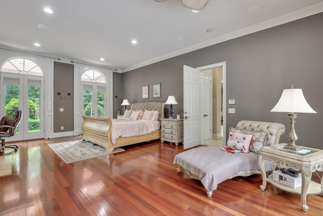 bedroom featuring wood-type flooring, access to exterior, crown molding, and french doors