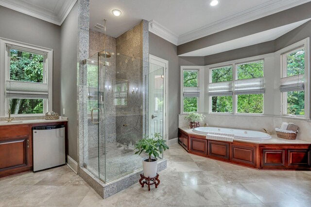 bathroom featuring crown molding, shower with separate bathtub, and vanity