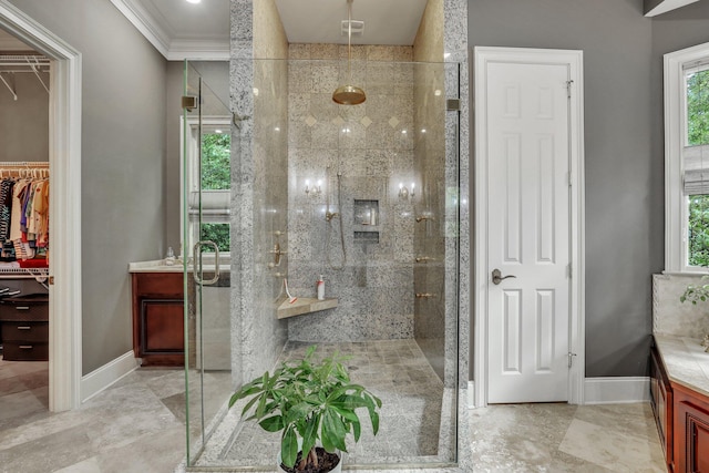 bathroom with vanity, plenty of natural light, ornamental molding, and a shower with shower door