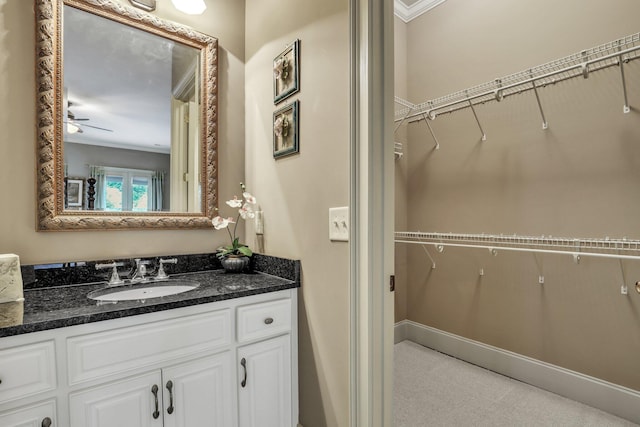 bathroom featuring vanity, ceiling fan, and ornamental molding