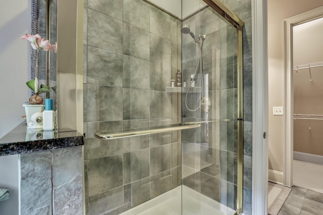 bathroom with tile patterned flooring and a shower with door