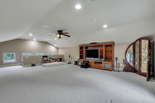 interior space with vaulted ceiling, ceiling fan, and carpet