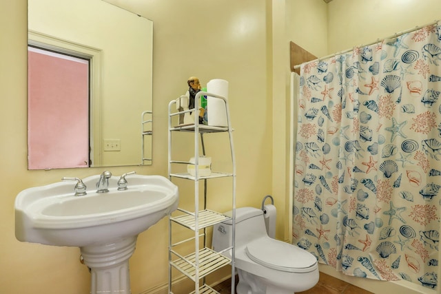 bathroom with walk in shower and toilet